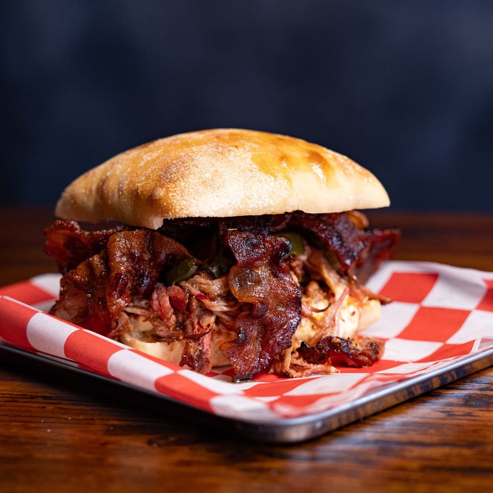Pulled pork sandwich on a tray.